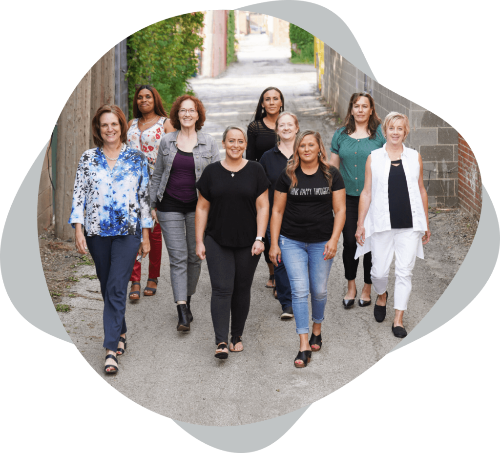 A group of women walking down a street